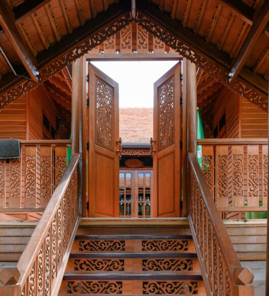 Classic asian wooden house with carving door opening