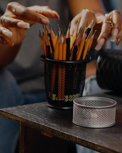 close-up-hand-holding-tea-cup-table