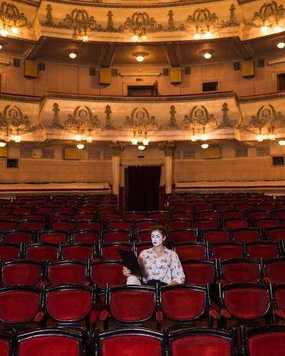 female-mime-with-manuscript-sitting-center-auditorium female-mime-with-manuscript-sitting-center-auditorium